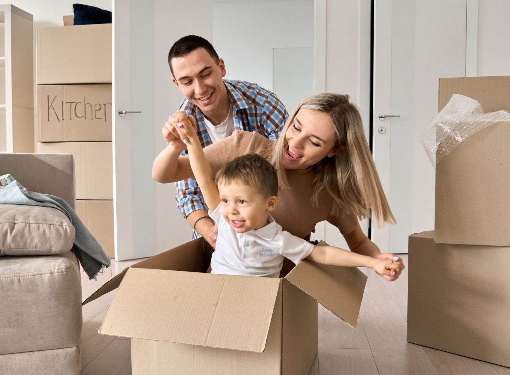 young couple and child moving home