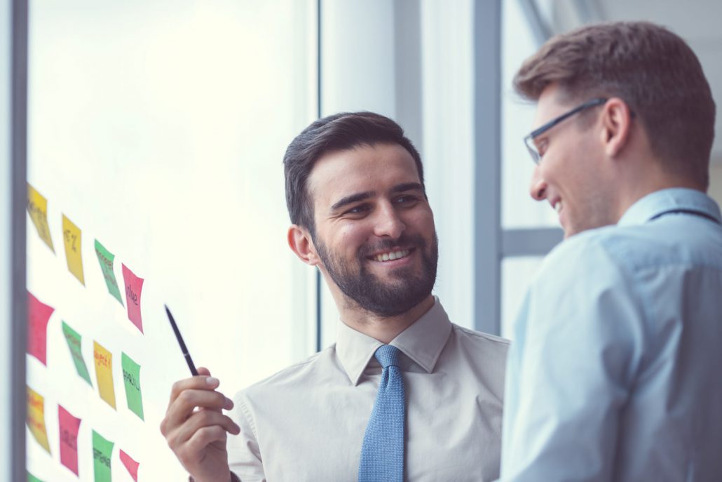 two male office workers talking