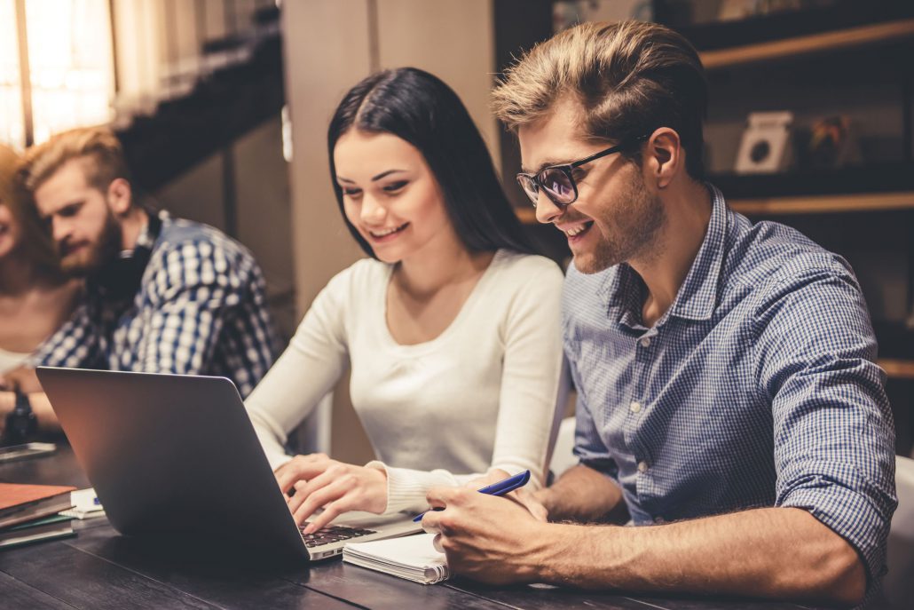 young couple looking at a laptop