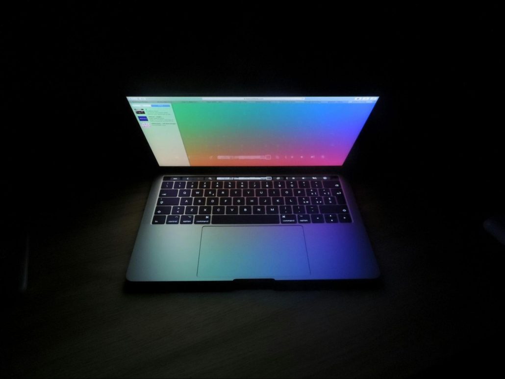 A glowing laptop in the dark