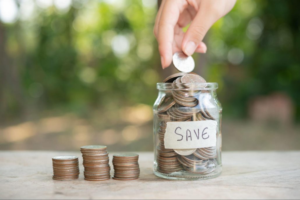 A hand drops coins into a jar labeled "sing," symbolizing saving and the joy of music.