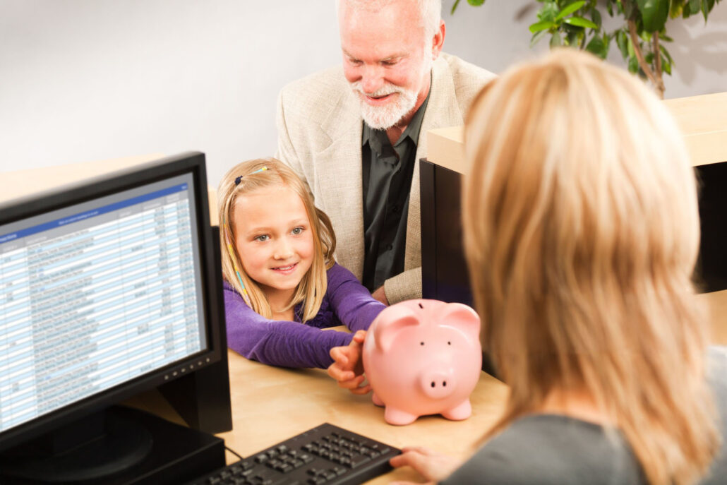 Opening a saving bank account with the bank teller in a retail bank counter.